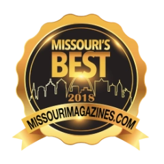A gold and black badge with the text "MISSOURI'S BEST 2018" and a city skyline silhouette, along with a ribbon reading "MISSOURIMAGAZINES.COM.